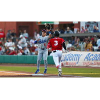 Tulsa Drillers' John Rhodes and Arkansas Travelers' Bill Knight in action