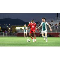 Phoenix Rising's Jearl Margaritha and Detroit City FC's Abdoulaye Diop in action